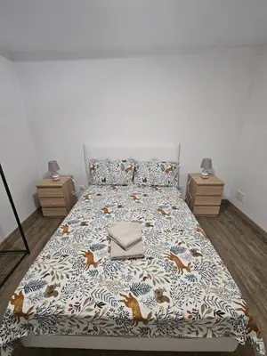 a bedroom with a bed and two night stands at Bela Vista House in Funchal