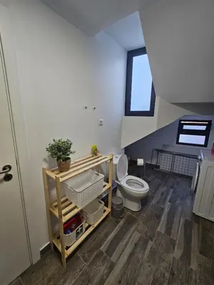 a bathroom with a toilet and a window at Bela Vista House in Funchal