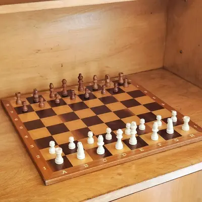 a wooden chess board with a chess set on it at Sol I in Funchal