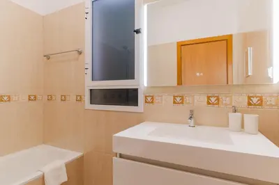 a bathroom with a white sink and a mirror at Casa Mieiro - Porto Santo in Porto Santo