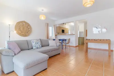 a living room with a couch and a table at Casa Mieiro - Porto Santo in Porto Santo