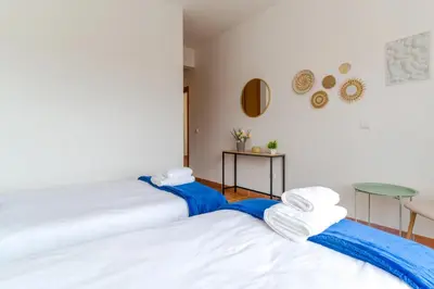 two beds sitting next to each other in a room at Casa Mieiro - Porto Santo in Porto Santo