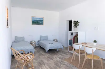 a living room with a bed and a table and chairs at CoWorking and CoLiving Villa in Sagres