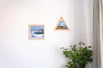 two pictures hanging on a wall next to a plant at CoWorking and CoLiving Villa in Sagres