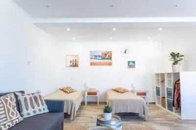 a living room with two beds and a couch at CoWorking and CoLiving Villa in Sagres