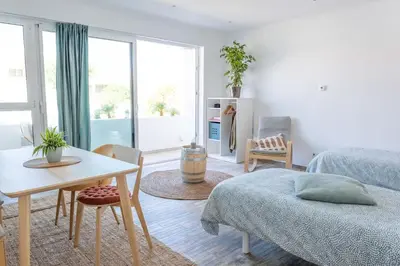 a living room with a bed and a table and a tableablish at CoWorking and CoLiving Villa in Sagres