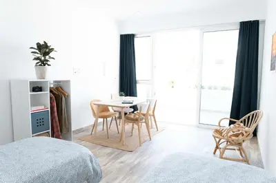 a bedroom with a table and chairs and a window at CoWorking and CoLiving Villa in Sagres