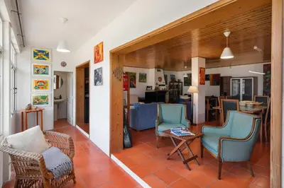 a living room with two chairs and a table at Retiro do Artista art and views over the valley in São Vicente