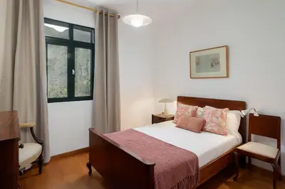 a bedroom with a bed and a window at Retiro do Artista art and views over the valley in São Vicente