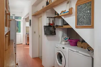 a laundry room with a washer and dryer and a chalkboard at Retiro do Artista art and views over the valley in São Vicente