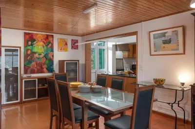 a kitchen and dining room with a table and chairs at Retiro do Artista art and views over the valley in São Vicente