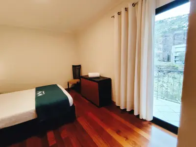 a bedroom with a bed and a large window at Coastal Comfort at Riverside - 4 Min to Airport! in Santa Cruz