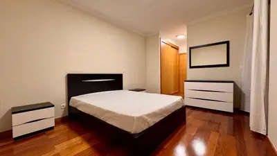 a bedroom with a bed and two dressers in it at Coastal Comfort at Riverside - 4 Min to Airport! in Santa Cruz