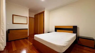 a bedroom with a white bed and a wooden floor at Coastal Comfort at Riverside - 4 Min to Airport! in Santa Cruz