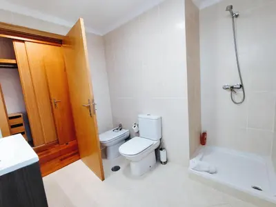 a bathroom with a toilet and a bath tub at Coastal Comfort at Riverside - 4 Min to Airport! in Santa Cruz