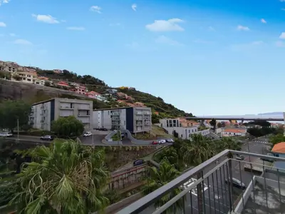 a view from a balcony of a city with a hill at Coastal Comfort at Riverside - 4 Min to Airport! in Santa Cruz