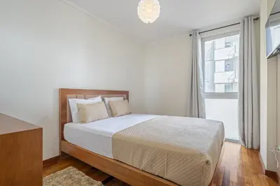 a white bedroom with a bed and a window at Nara by KAAMAH in Santa Cruz