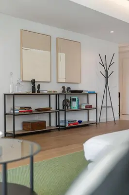 a living room with a book shelf and a plant at Acqua Residence VII - Luxury 3BR in Funchal in Funchal