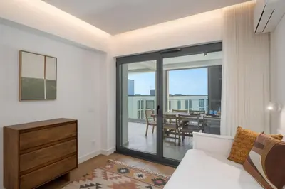 a living room with a white couch and a table at Acqua Residence VII - Luxury 3BR in Funchal in Funchal