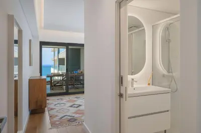 a bathroom with a door leading to a dining room at Acqua Residence VII - Luxury 3BR in Funchal in Funchal
