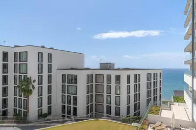 an apartment building with the ocean in the background at Acqua Residence VII - Luxury 3BR in Funchal in Funchal