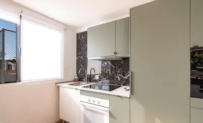 a white kitchen with a sink and a window at Magnolia Terrace by Amazing Madeira in Funchal