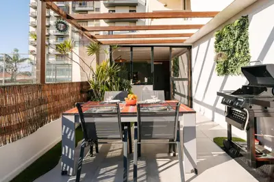 an outdoor patio with a table and a grill at Magnolia Terrace by Amazing Madeira in Funchal