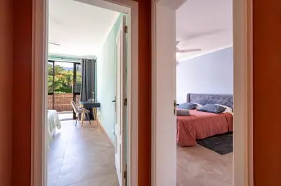 a door leading into a bedroom with a bed at Magnolia Terrace by Amazing Madeira in Funchal