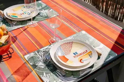 a table with two plates and wine glasses on it at Magnolia Terrace by Amazing Madeira in Funchal