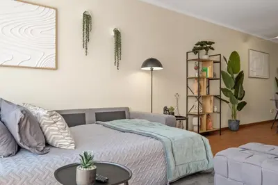 a bedroom with a bed and a couch and a table at SUPER Rabbit in Funchal