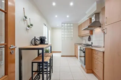 a kitchen with wooden cabinets and a counter top at SUPER Rabbit in Funchal