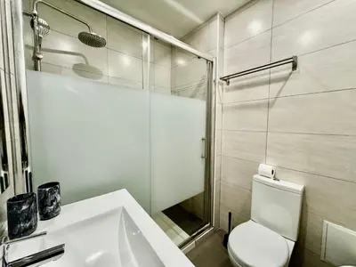 a bathroom with a toilet and a sink and a shower at O Mar a dois minutos in Luz