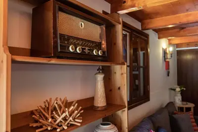 a living room with a shelf with a radio at Portas da Levada B by Rent-a-key in São Vicente