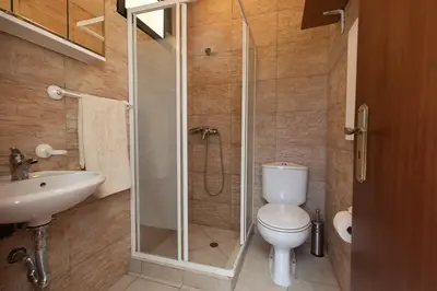 a bathroom with a shower and a toilet and a sink at Portas da Levada B by Rent-a-key in São Vicente