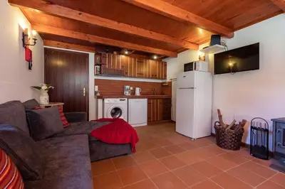 a living room with a couch and a kitchen at Portas da Levada B by Rent-a-key in São Vicente