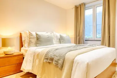 a bedroom with a white bed with a window at Casa do Pinheiro II, a Home in Madeira in São Vicente