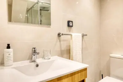 a bathroom with a white sink and a mirror at Casa do Pinheiro II, a Home in Madeira in São Vicente