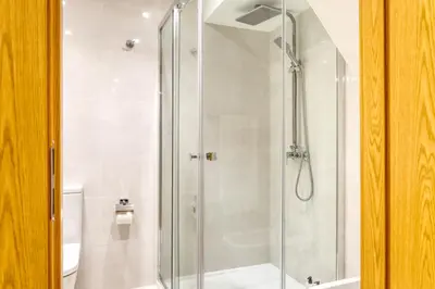 a shower with a glass door in a bathroom at Casa do Pinheiro II, a Home in Madeira in São Vicente