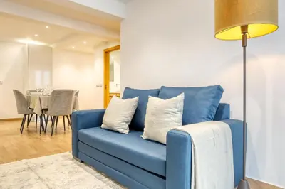 a blue couch in a living room with a table at Casa do Pinheiro II, a Home in Madeira in São Vicente