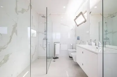 a bathroom with a shower and a toilet and a sink at Villa Amazing View Funchal - Lux & Pool in Funchal