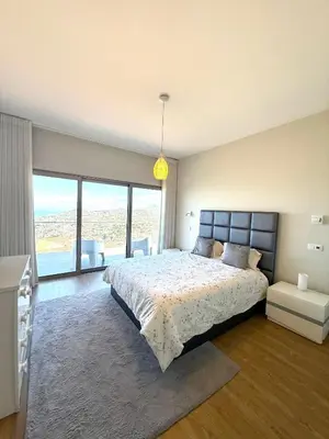 a bedroom with a large bed and a large window at Villa Amazing View Funchal - Lux & Pool in Funchal