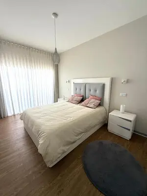 a bedroom with a large bed with two pink pillows at Villa Amazing View Funchal - Lux & Pool in Funchal