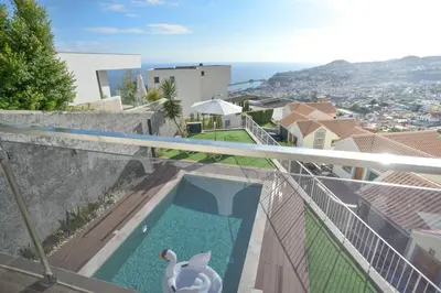 a swimming pool on the balcony of a house at Villa Amazing View Funchal - Lux & Pool in Funchal