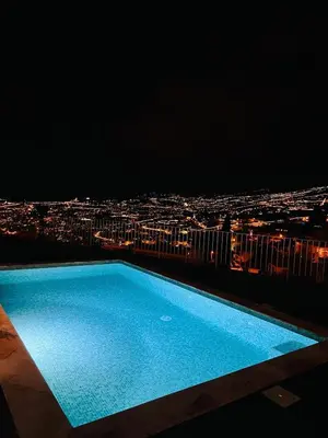 a swimming pool on top of a building at night at Villa Amazing View Funchal - Lux & Pool in Funchal
