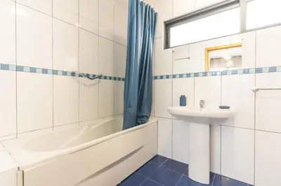 a bathroom with a sink and a bath tub and a toilet at Porlamar Apartment by Atlantic Holiday in Calheta