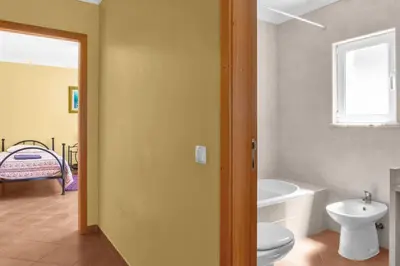 a bathroom with a toilet and a tub and a sink at L40 Villa & Pool- Vale da Telha, Aljezur in Aljezur