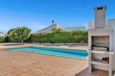 a swimming pool in front of a house with a fireplace at L40 Villa & Pool- Vale da Telha, Aljezur in Aljezur