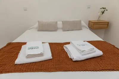 a bedroom with two beds with towels on them at A20 - Beco Luz Studio in Luz