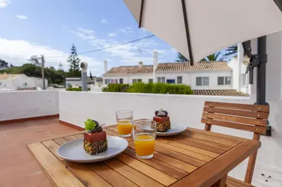 a table with two plates of food and glasses of orange juice at A20 - Beco Luz Studio in Luz