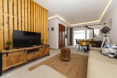 a living room with a flat screen tv on a wooden entertainment center at A20 - Beco Luz Studio in Luz